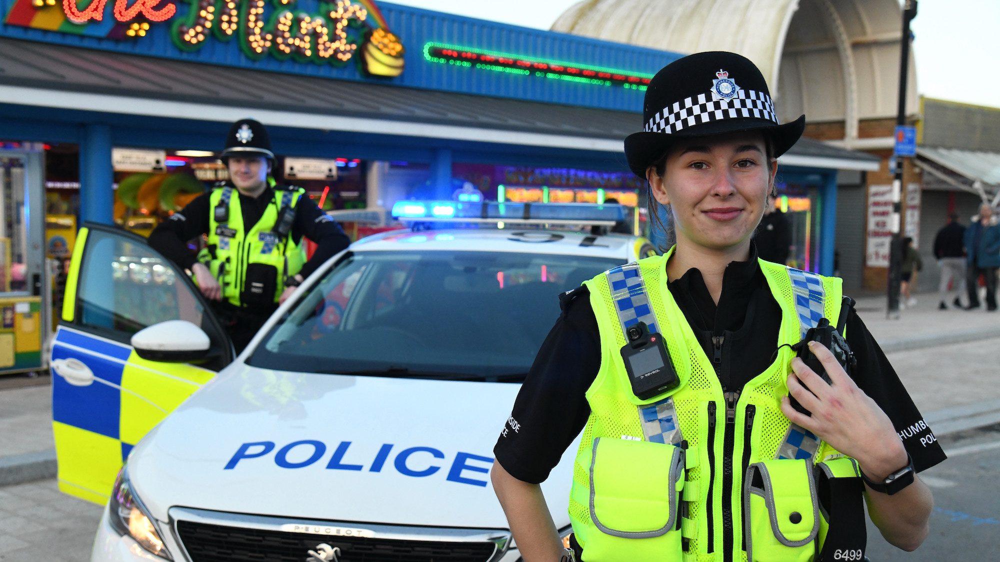 Special Constables stood beside patrol car